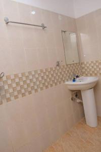 a bathroom with a sink and a mirror at 2 B/room Nyali City Mall W/Pool in Mombasa