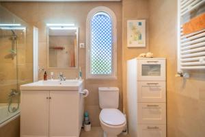 ein Badezimmer mit Toilette und Waschbecken und einem Fenster in der Unterkunft 2 Bed Flat/Apartment on La Torre Golf Resort in Torre-Pacheco + 11 Fotos