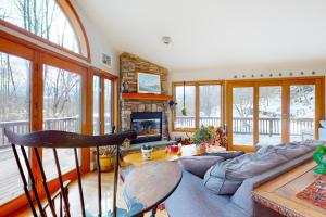 a living room with a couch and a fireplace at Ski Bike the East in Stowe