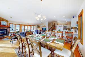 a dining room and living room with a table and chairs at Ski Bike the East in Stowe