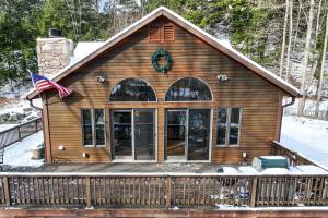 a house with a flag on the front of it at Ski Bike the East in Stowe