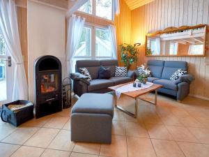 a living room with couches and a fire place at Strandpark Baabe Haus 250 in Baabe