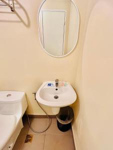 a bathroom with a sink and a mirror at B Avida Tower in Iloilo City