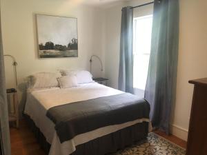 a bedroom with a large bed and a window at Luxurious indoor/outdoor Family Paradise in downtown St Augustine in Saint Augustine