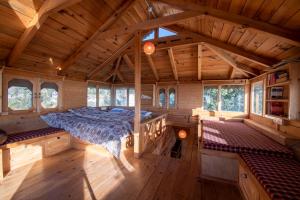 a bedroom in a wooden house with a bed in it at Naddi Castle in McLeod Ganj