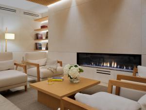 a living room with a fireplace and white furniture at Hotel Saratoga in Palma de Mallorca