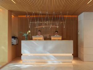 two people sitting at a desk with their laptops at Hotel Saratoga in Palma de Mallorca