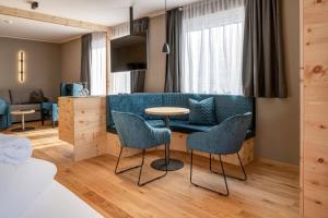 salon ze stołem i krzesłami w obiekcie Naturhotel Tandler w mieście Sankt Jakob in Defereggen