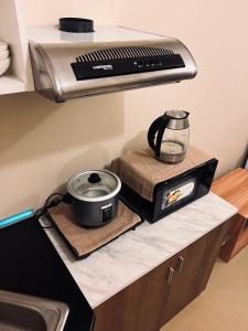 a kitchen counter with a toaster and a slow cooker at B Avida Tower in Iloilo City