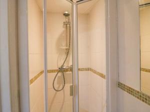 a shower with a glass door in a bathroom at Lobster Cottage in Weymouth +22 photos