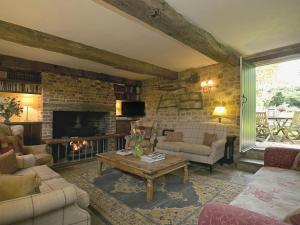 a living room with a couch and a fireplace at Old Rectory Barn in Fernhurst