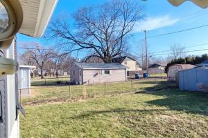 a view of a yard with a house at Perfect Combo of Charm & Comfort- 2Bedroom Home in Noblesville