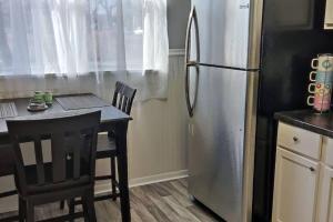 a kitchen with a refrigerator and a table and chairs at Perfect Combo of Charm & Comfort- 2Bedroom Home in Noblesville