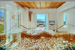 a bedroom with a bed with rocks on it at Zinas Villas in Fanari