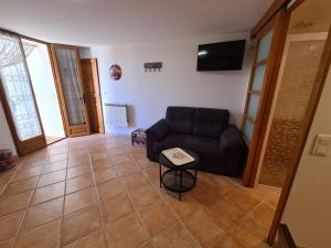 a living room with a couch and a table at Studio Vintage in Carnoules