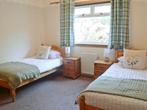 a bedroom with two beds and a window at Canisp View in Achmelvich