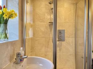 a bathroom with a sink and a shower at The Cove in Deal