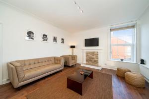a living room with a couch and a tv at 1 Shore in Arbroath