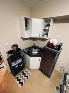 a small kitchen with a sink and a stove at B Avida Tower in Iloilo City