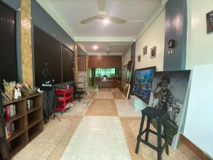 a living room with a ceiling fan and a hallway at Freedom8 in Khlong San