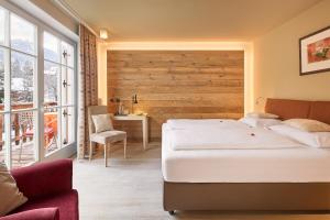 Postel nebo postele na pokoji v ubytování Dolomit Boutique Hotel