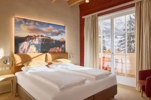 Postel nebo postele na pokoji v ubytování Dolomit Boutique Hotel