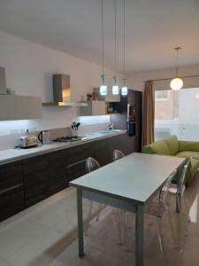a kitchen and living room with a table and chairs at Sliema Apartment close to BEACH in Sliema