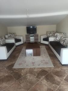 a living room with couches and a flat screen tv at Denize sıfır 2 yatak odalı daire D 8 in Tekirdag