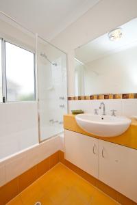 a bathroom with a sink and a shower at Ocean Mist Villa in Albany