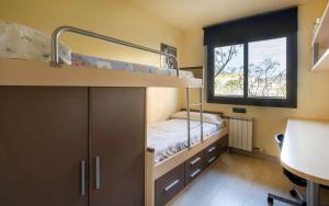 a small room with a bunk bed and a window at Josep Mº Folch Centro in Tossa de Mar