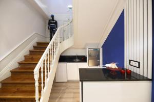 a kitchen with a staircase with a black counter top at FLH Porto Downtown GuestHouse in Porto