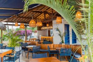 a restaurant with tables and chairs and lights at Vila Gallina Pousada in Jericoacoara