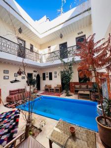 a house with a swimming pool in a yard at Riad 46 in Marrakesh