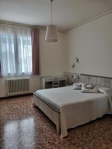 Il Colibrì Bed&Breakfast في Leno: غرفة نوم بيضاء مع سرير كبير ونافذة