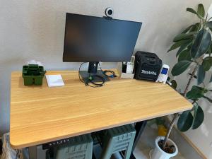 a computer monitor sitting on top of a wooden desk at ゲストハウス 西村サイクル（24C） in Izume