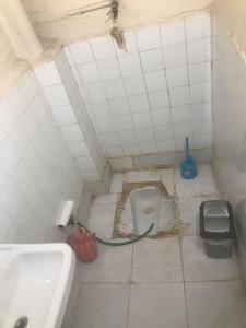 a small bathroom with a toilet in the floor at House in Kayapınar