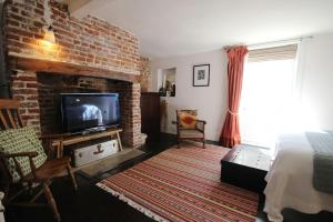 a bedroom with a bed and a brick wall at Skippers in Deal