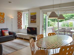 a living room with a table and a couch at Lo-tide in Middleton-on-Sea