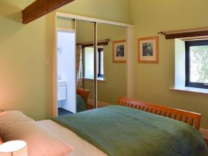 a bedroom with a bed and a window at The Byre in Westerdale