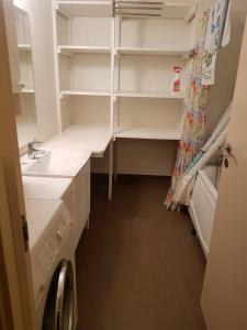 a small bathroom with a sink and a closet at Leilighet(75m²)+hage(40m²) 20 min fra sentrum in Grorud