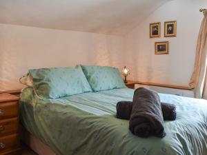 a bed with a stuffed animal on top of it at Tinners Gate in Saint Cleer