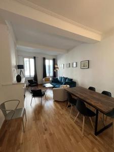 a living room with a table and a couch at La Comédie, appart de Charme in Montpellier