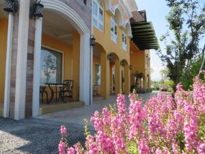 a house with pink flowers in front of it at Jane Castle in Wujie