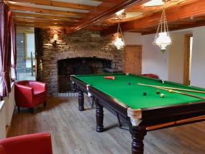 a room with a pool table and a fireplace at The Farmhouse - Ukc1339 in North Molton