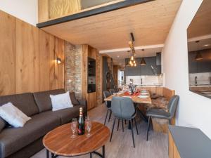 een woonkamer met een bank en een tafel bij Apartment Les Hauts du Val Claret - Val Claret-23 by Interhome in Tignes
