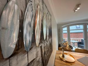 a bathroom with several surfboards on a wall at Hygge Nest im Haus Mateika in Westerland (Sylt) +22 photos