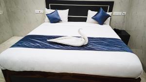 a white swan is laying on a bed at HOTEL DIVINE RAMESHWARAM in Rāmeswaram