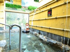 a water fountain in the side of a building at Kikuchi Grand Hotel in Kikuchi