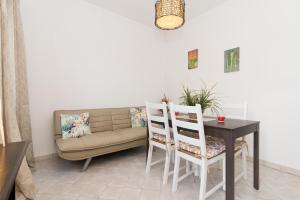 a living room with a couch and a table and chairs at Casa Florinda in Tavira