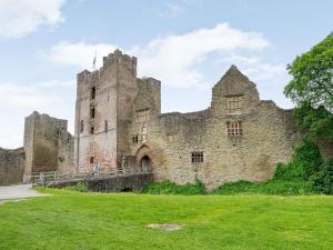 an old castle with a grass field in front of it at Sir Henry Sidney-ukc4033 in Ludlow